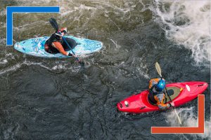 Two kayakers navigating a river from above, symbolizing real-time decision-making and data-driven journeys