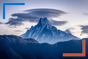 Snow-capped Machapuchare mountain with dramatic lenticular clouds at dawn